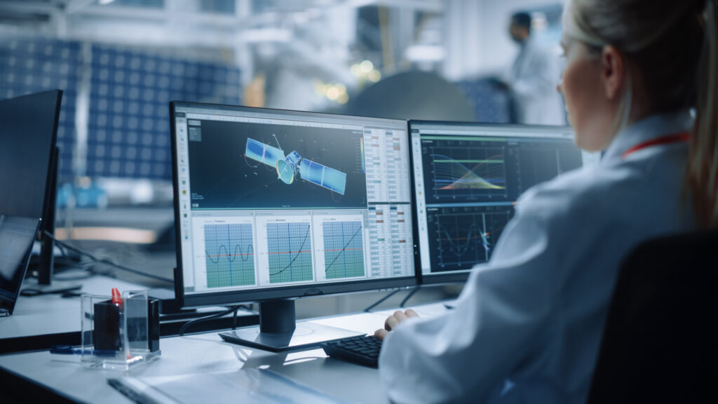 Female Engineer uses Computer to Analyse Satellite, Calculate Or