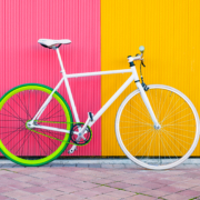 City bicycle fixed gear on yellow and red wall.