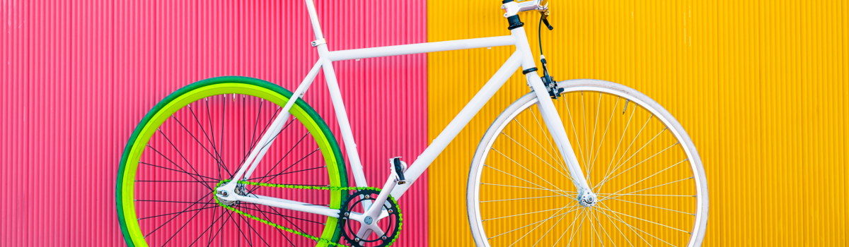 City bicycle fixed gear on yellow and red wall.